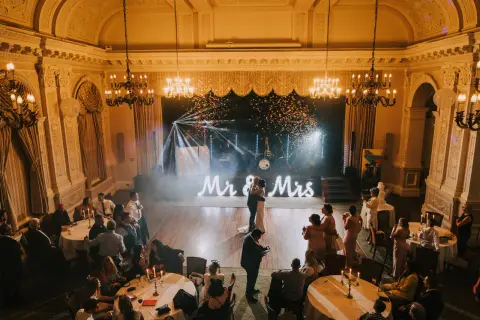 A burst of confetti above a wedding couple on the dance floor