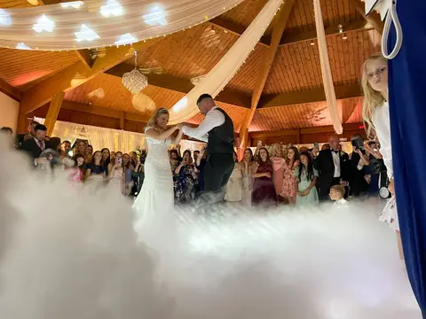 Wedding couple sharing a first dance surrounded by a low-lying cloud effect