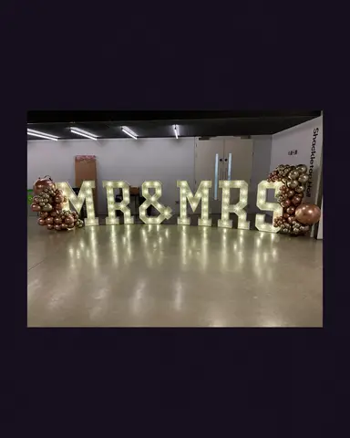 Bulb-lit MR & MRS letters displayed with balloon decorations