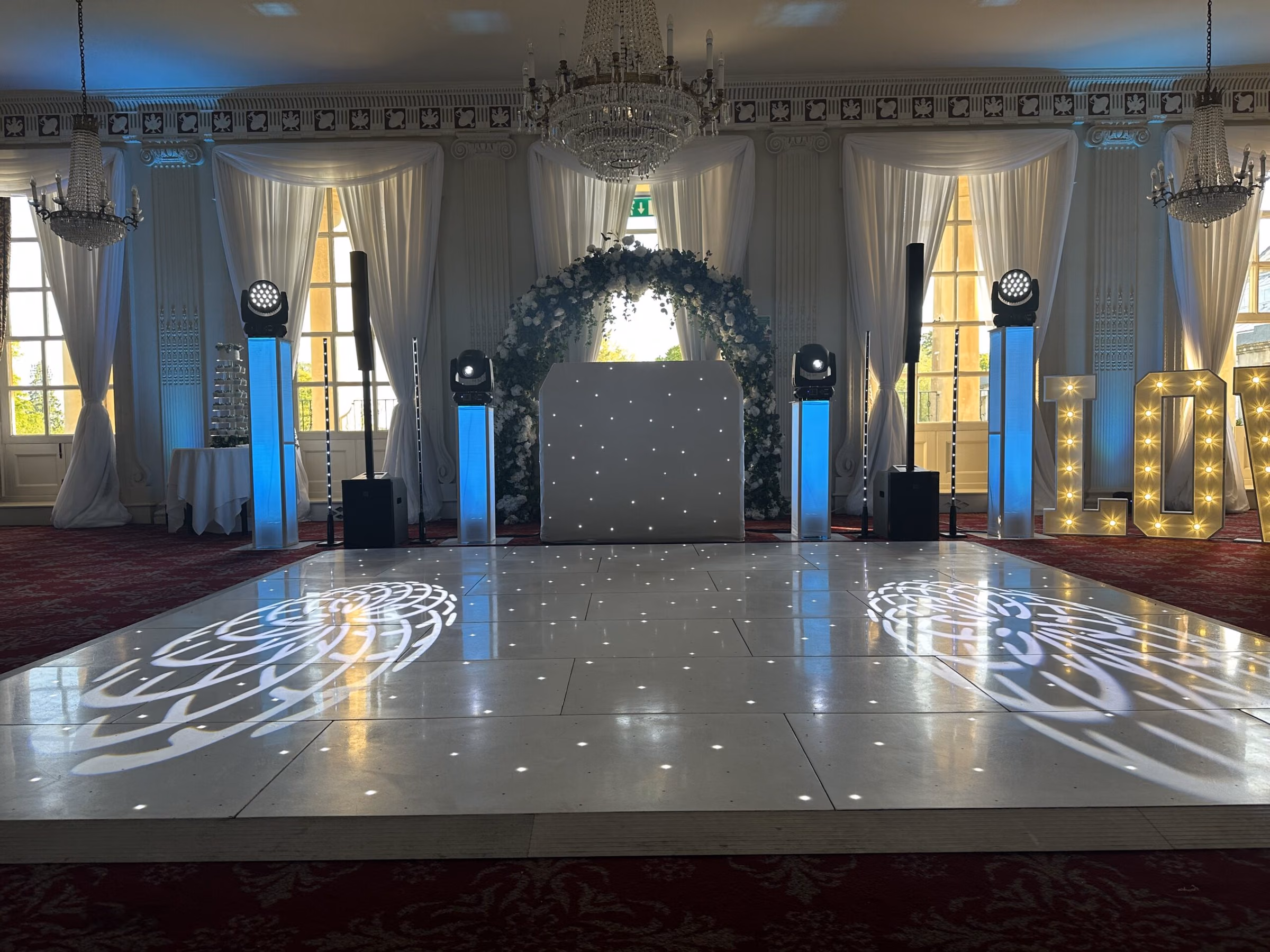 White LED starlit dance floor in front of a wedding DJ setup