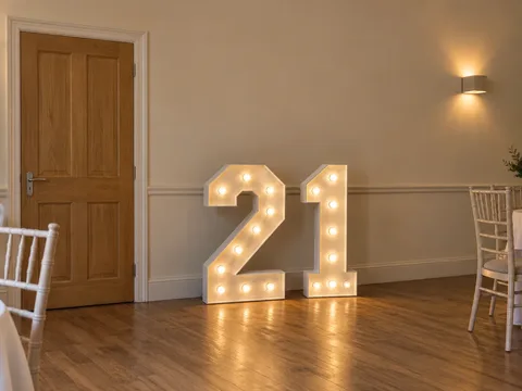 Four-foot illuminated 21 numbers in a wedding venue
